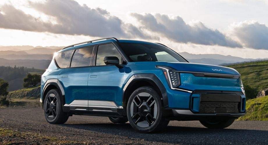 2026 KIA EV9 in blue on a gravel road in the countryside. Shop KIA EV9 today at Castle KIA McHenry.