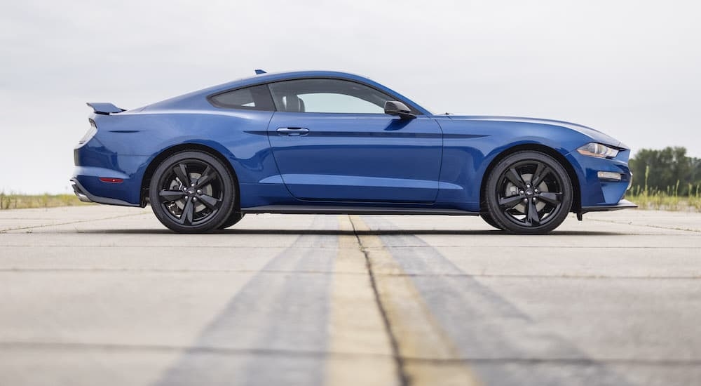 A blue 2022 Ford Mustang from the side after the owner researched how to 'sell my car'.