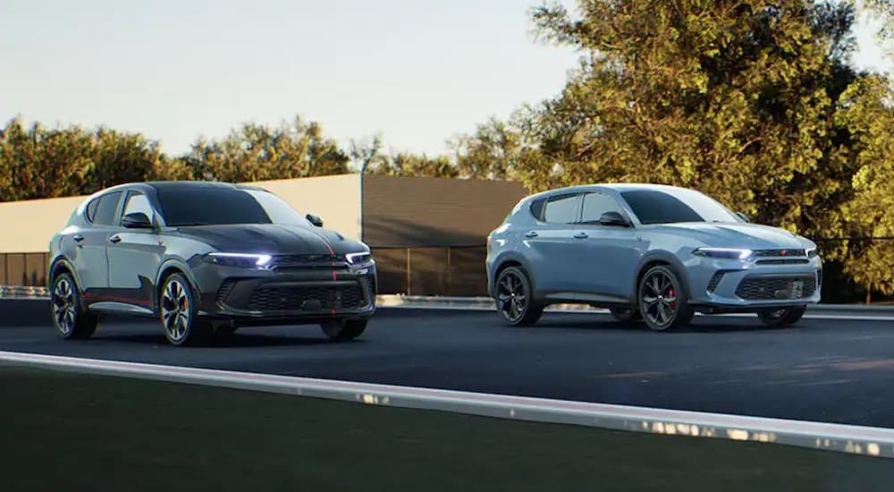 A black and a grey 2025 Dodge Hornet from the front at an angle.