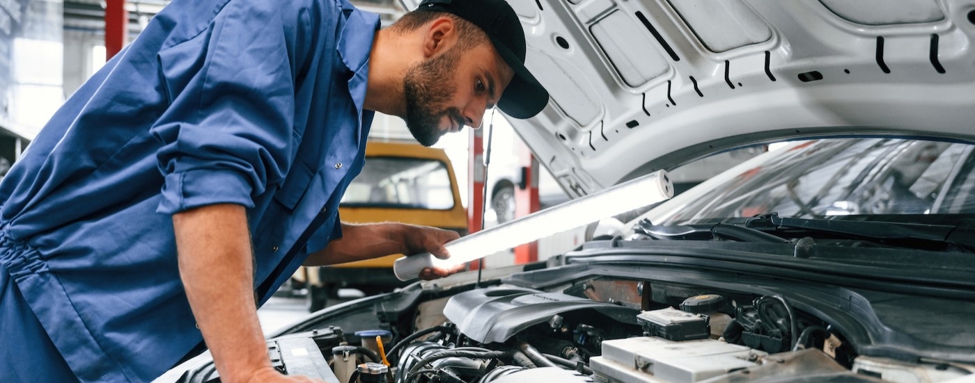 A technician inspecting an engine.