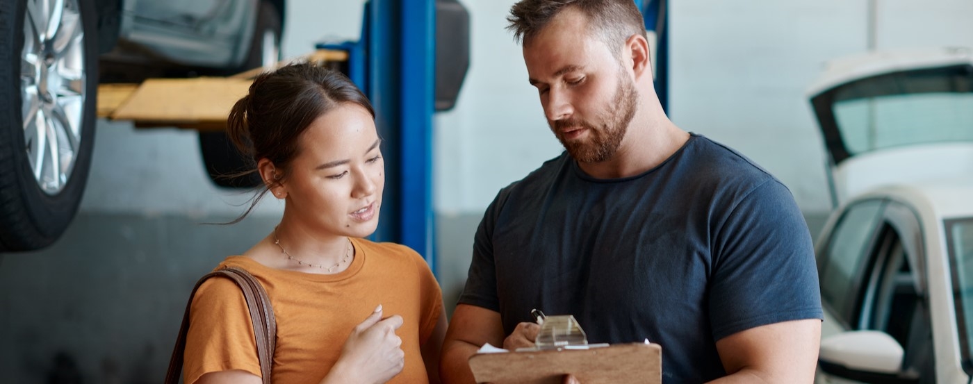 Two people talking at a Honda service center.