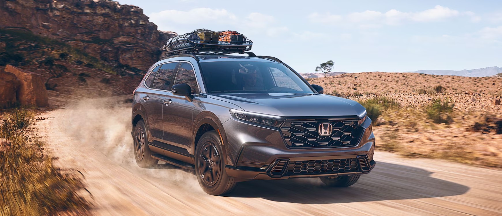 A gray 2024 Honda CR-V Sport Touring off-roading.