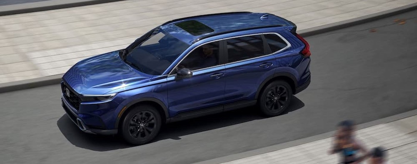 A blue 2025 Honda CR-V driving to a Honda dealer near Elizabeth.
