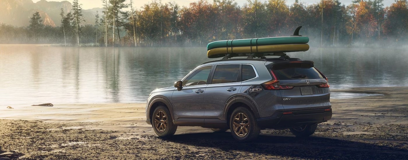 A gray 2026 Honda CR-V HPD Package parked near a lake.