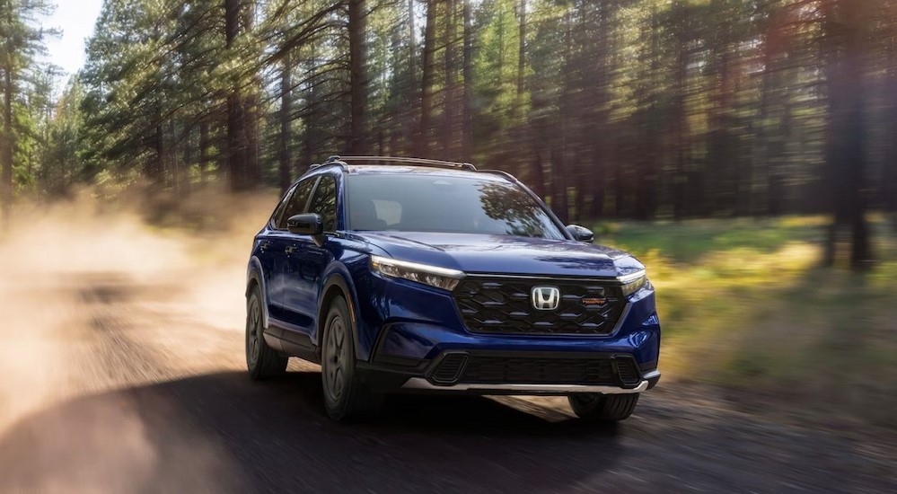 A blue 2026 Honda CR-V TrailSport off-roading.