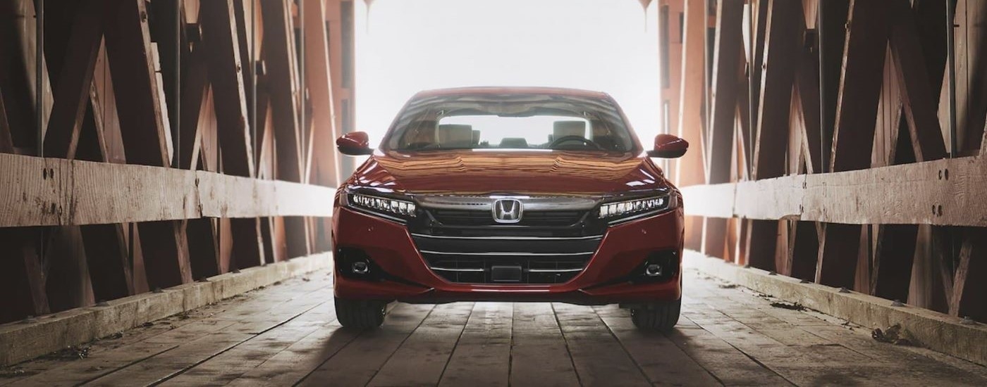 A red 2021 Honda Accord parked on a covered bridge.