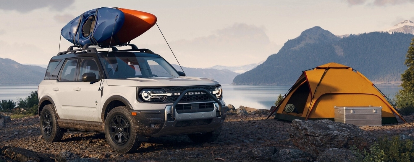A white 2025 Ford Bronco Sport OuterBanks parked at a campsite.
