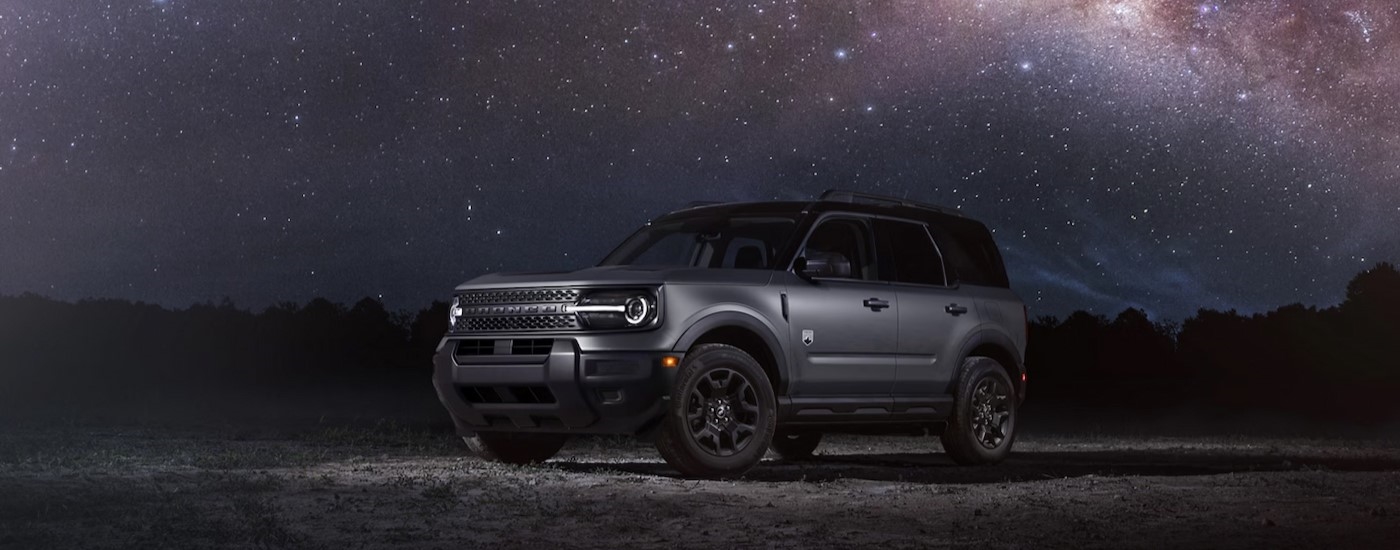 A gray 2025 Ford Bronco Sport parked on a starry night.
