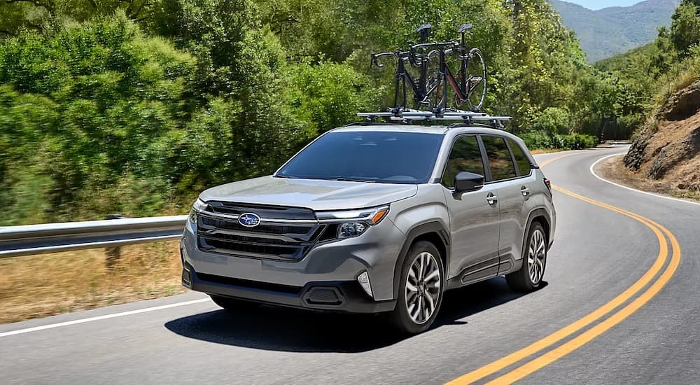 Grey 2025 Subaru Forester Hybrid for sale in Rhinebeck driving around a bend.