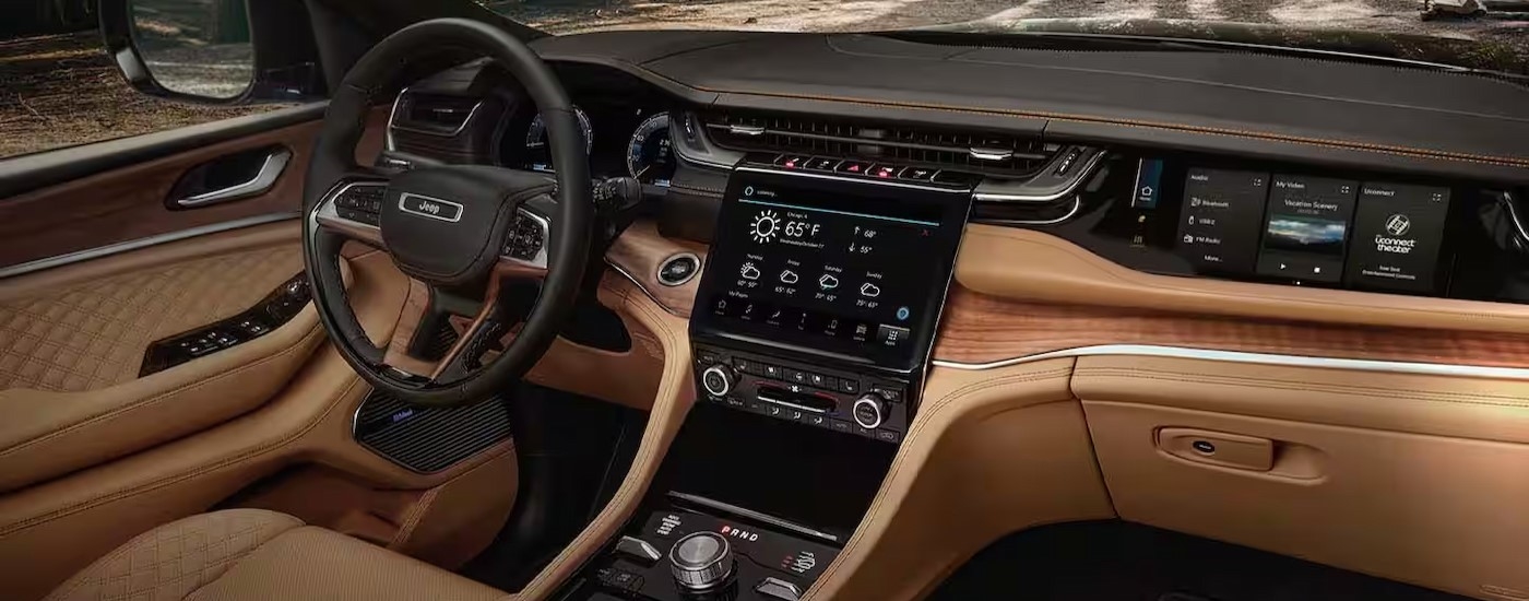 The black and brown interior and dash in a 2025 Jeep Grand Cherokee for sale near Hyde Park.