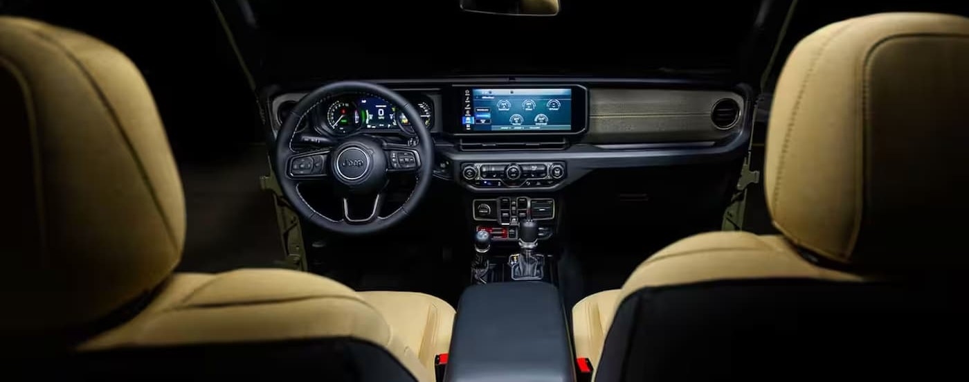 The black and brown interior and dash in a 2025 Jeep Wrangler for sale near Hyde Park.