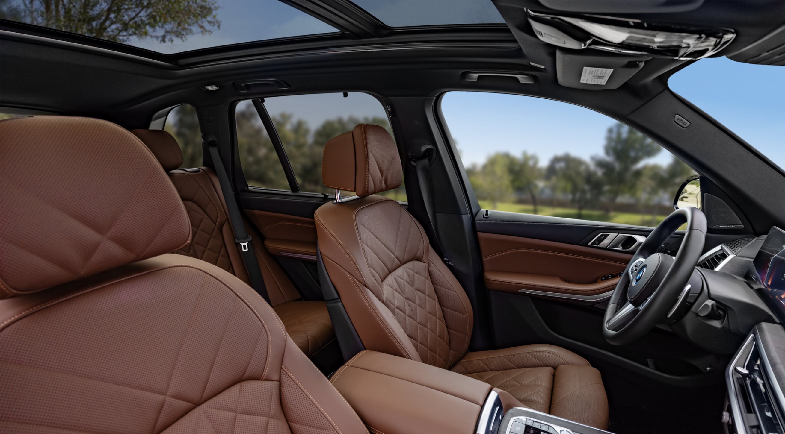 Interior cabin view of the 2026 BMW X5 featuring the advanced digital Curved Display and premium leather seating