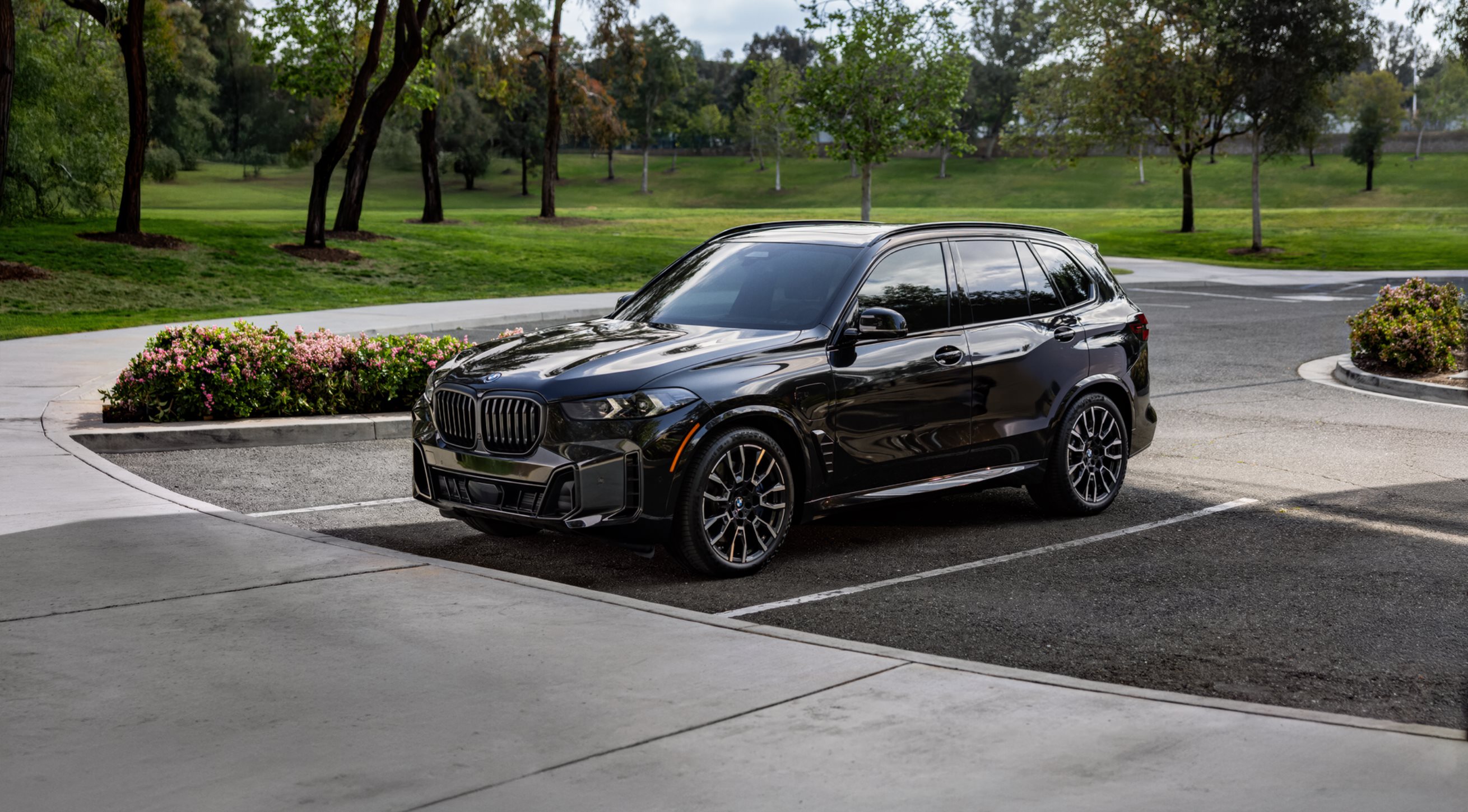 Close-up detailing the aggressive front bumper fascia and aerodynamic lines of the BMW X5