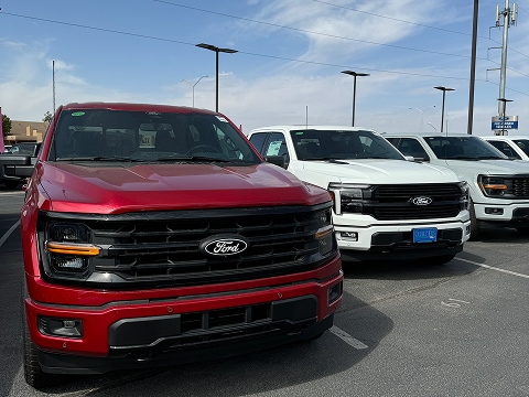 red 2025 Ford F-150 truck parked at the Chalmers Ford dealership in Albuquerque, NM