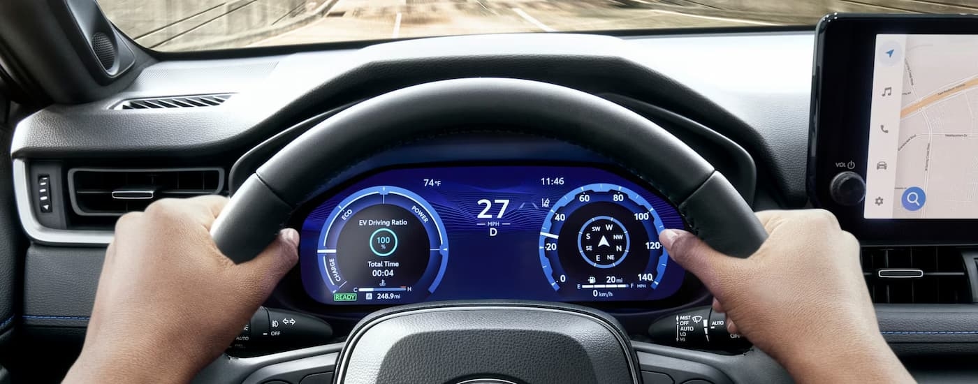 Hands holding steering wheel in a 2025 Toyota RAV4