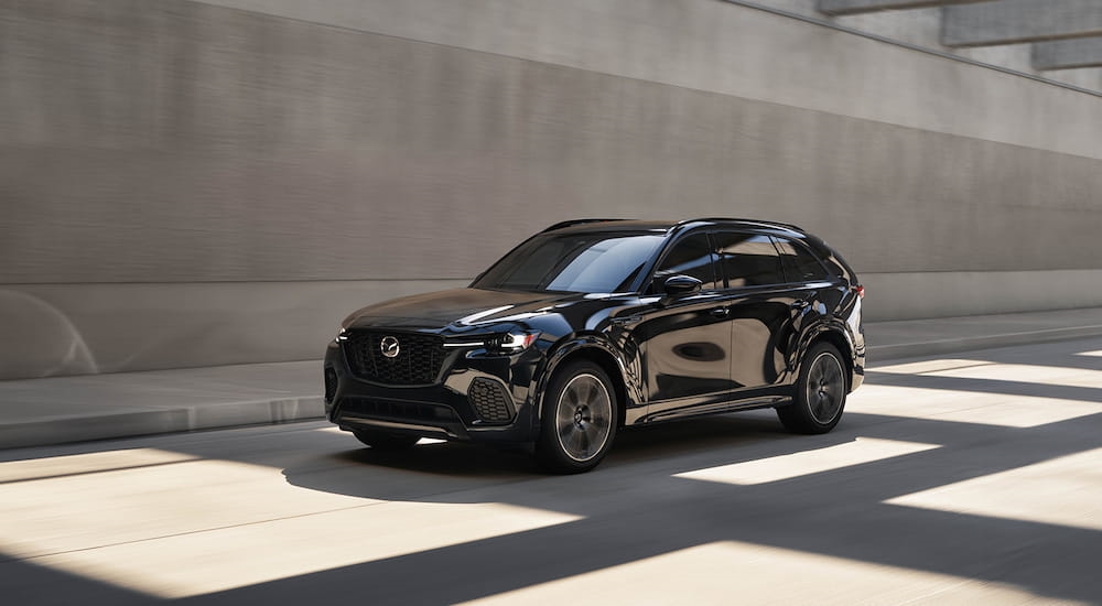 Black 2025 Mazda CX-70 for sale driving through a tunnel.