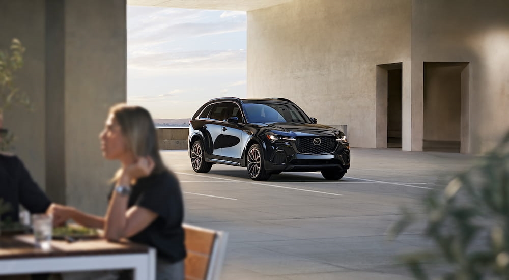 Black 2025 Mazda CX-70 parked at a restaurant.