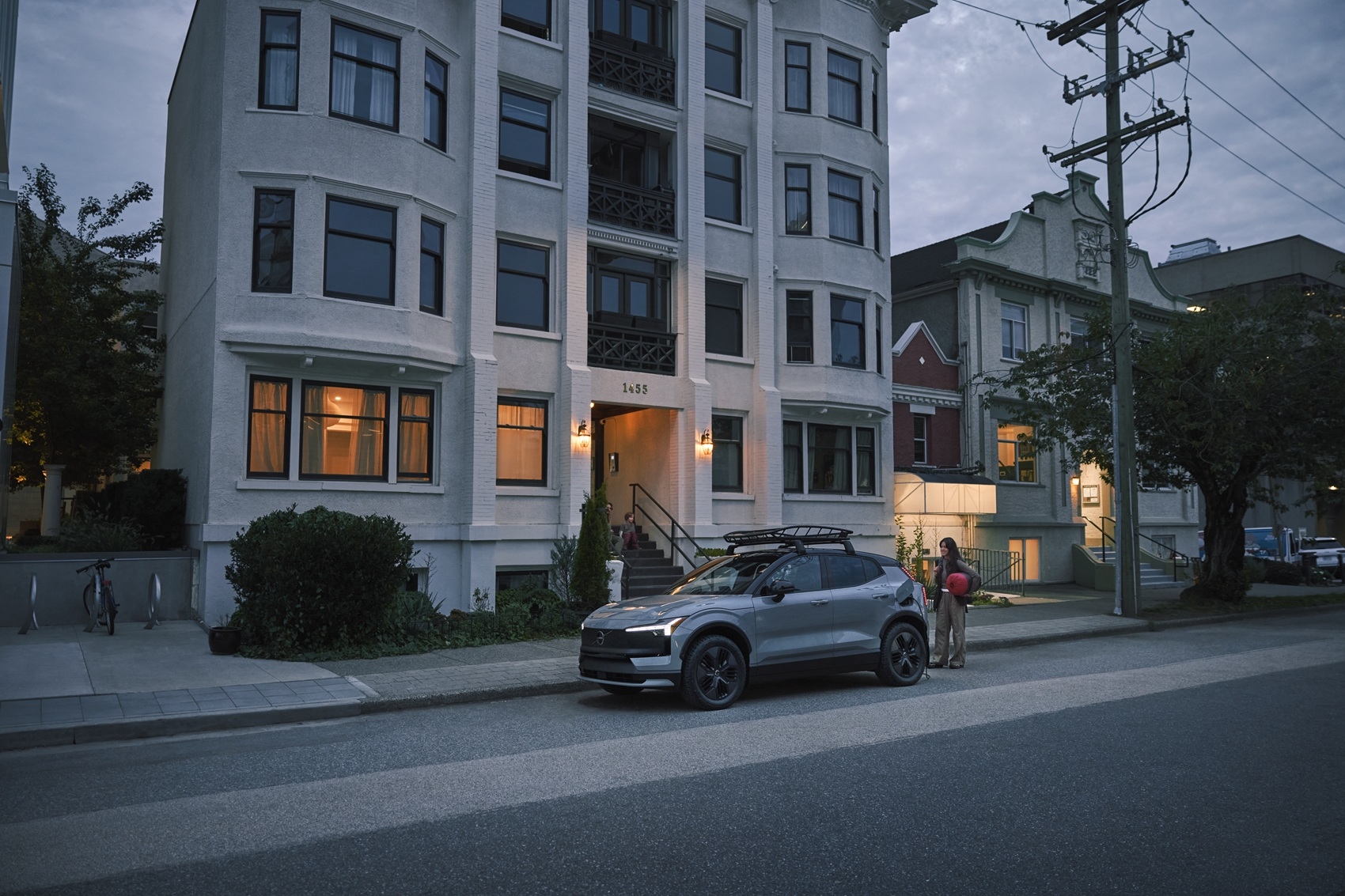 Volvo EX30 Cross Country parked on the street in front of apartment building