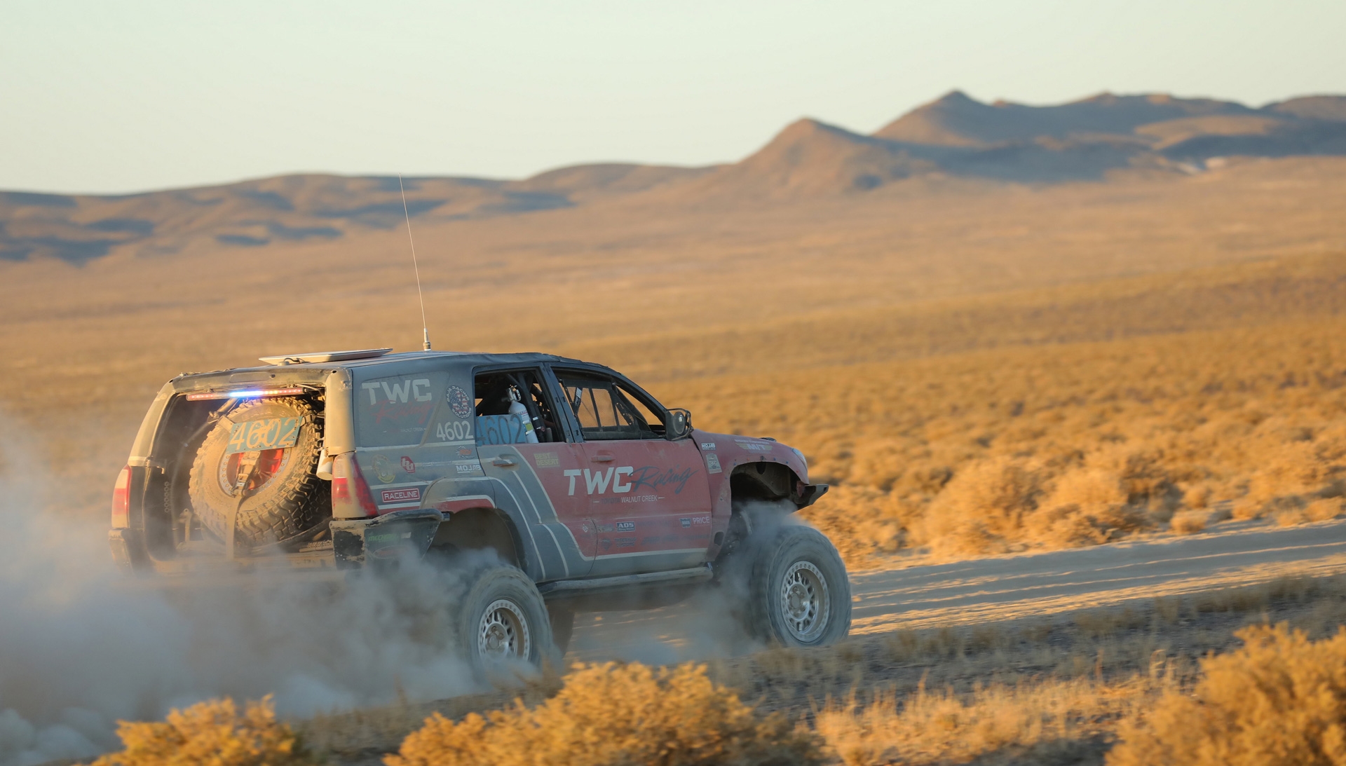 TWC Racing truck in desert at sunset
