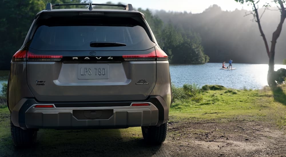Rear of a grey 2026 Toyota RAV4 parked near a lake