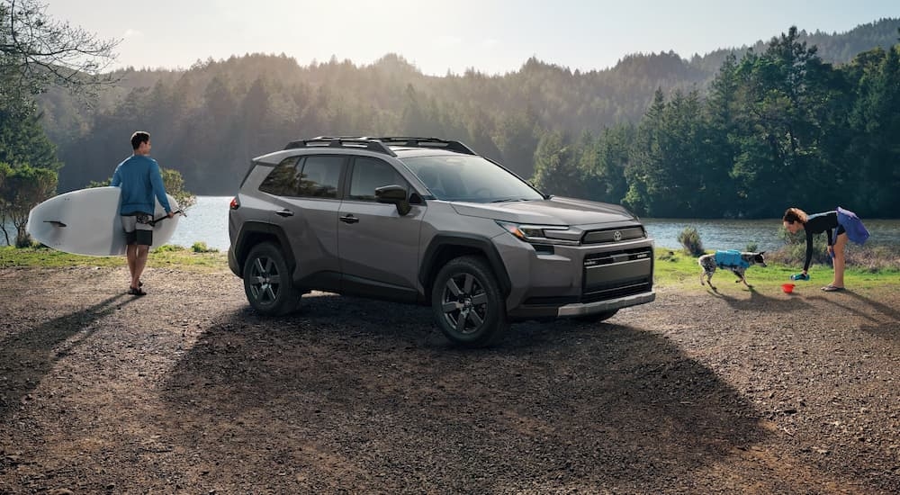 Grey 2026 Toyota RAV4 parked on gravel near a river
