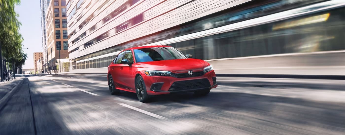 A red 2025 Honda Civic from the front at an angle.