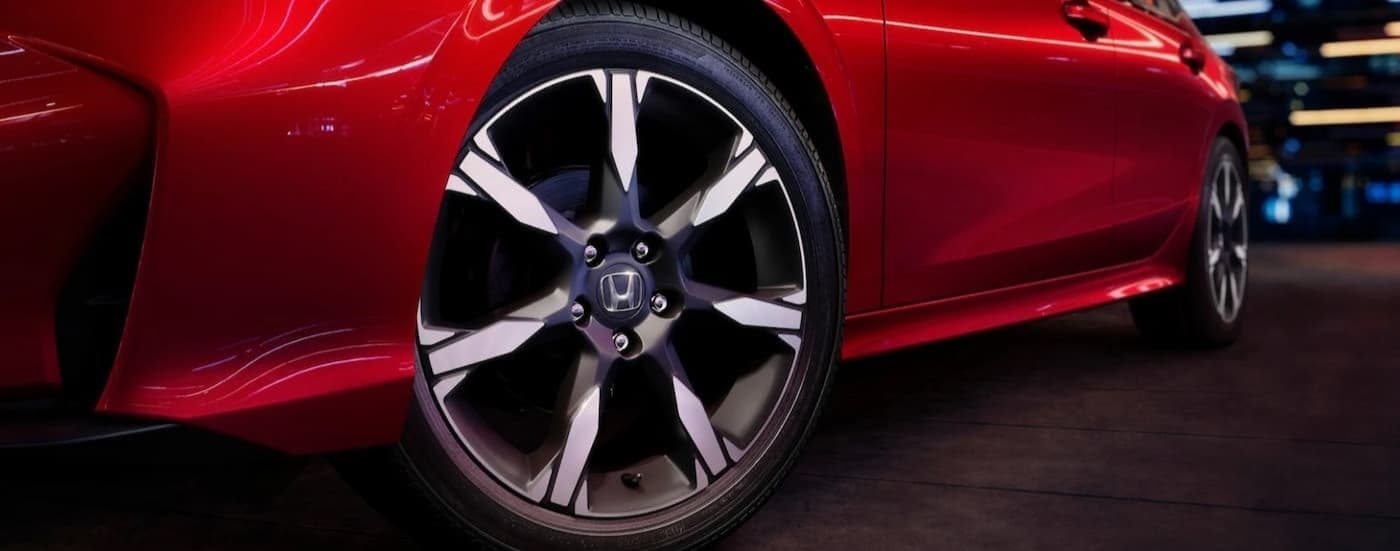 Close-up of a wheel on a red 2026 Honda Civic.