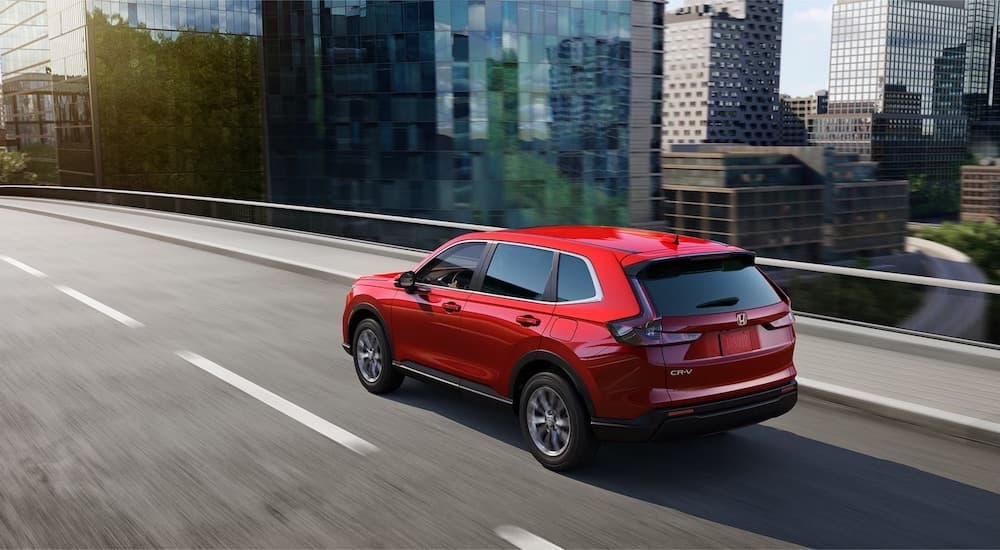 A red 2025 Honda CR-V from the rear at an angle.