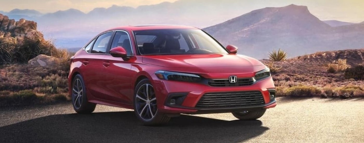 A red 2023 Honda Civic parked near a cliff.