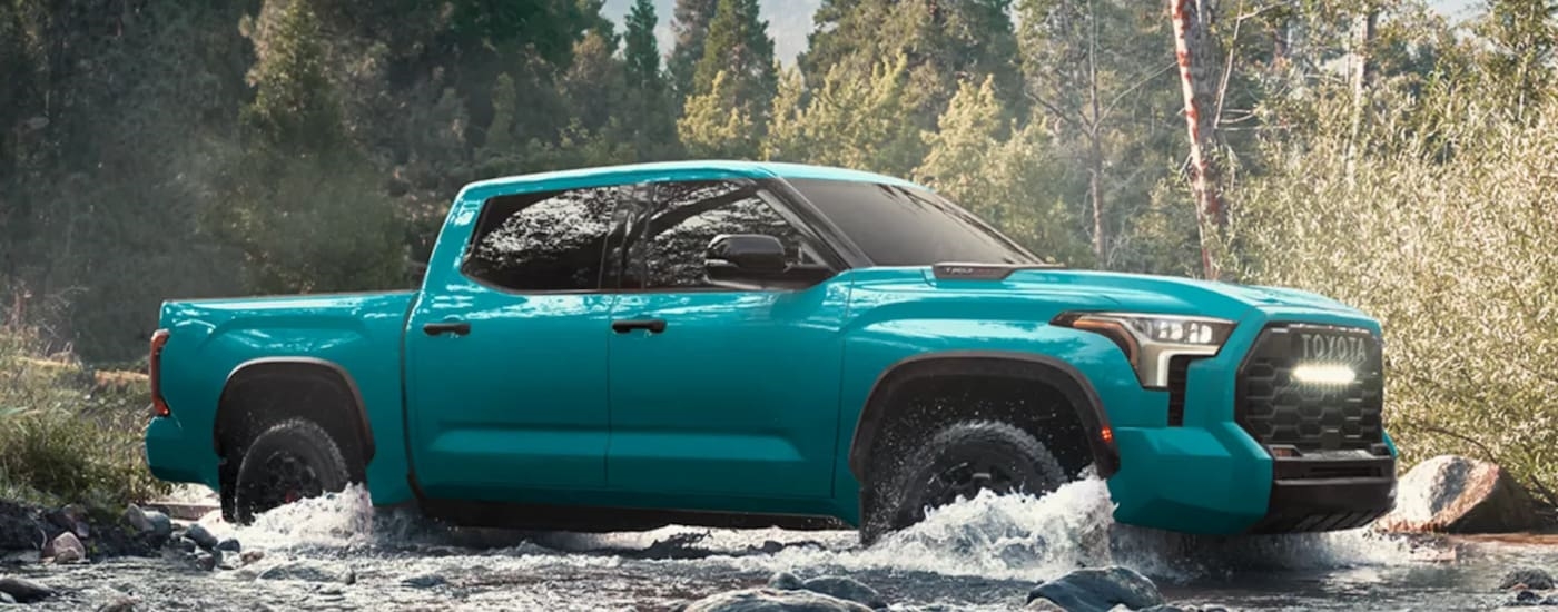 Blue 2026 Toyota Tundra TRD Pro for sale near Bennington driving over a shallow river.
