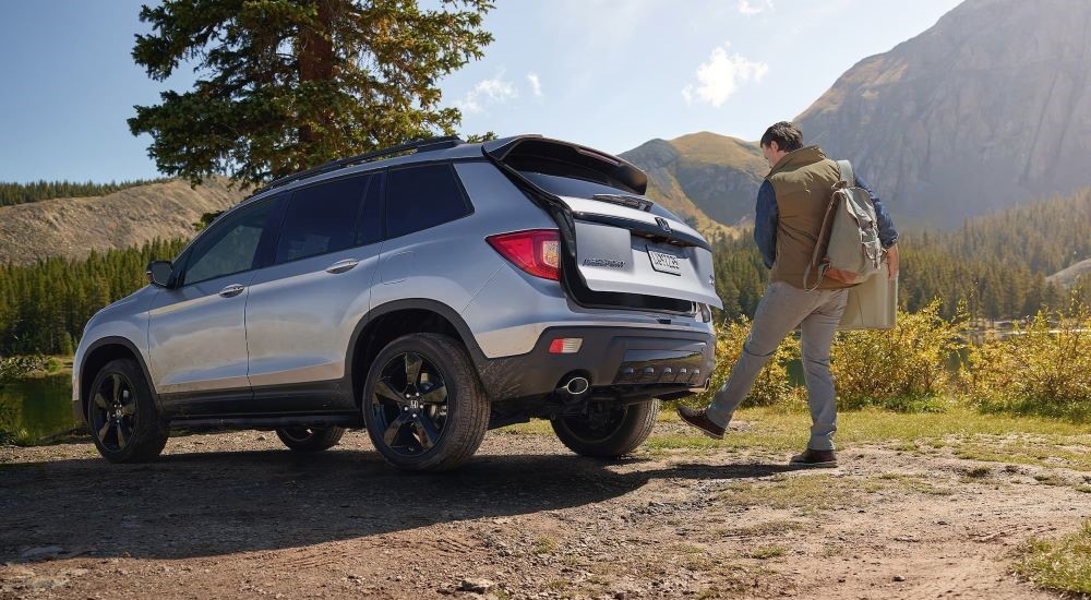 A silver 2021 Honda Passport parked off-road.