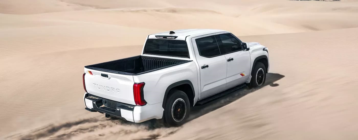 White 2026 Toyota Tundra driving off-road.