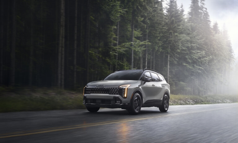 2026 Kia Sportage Exterior Driving On Forest Road