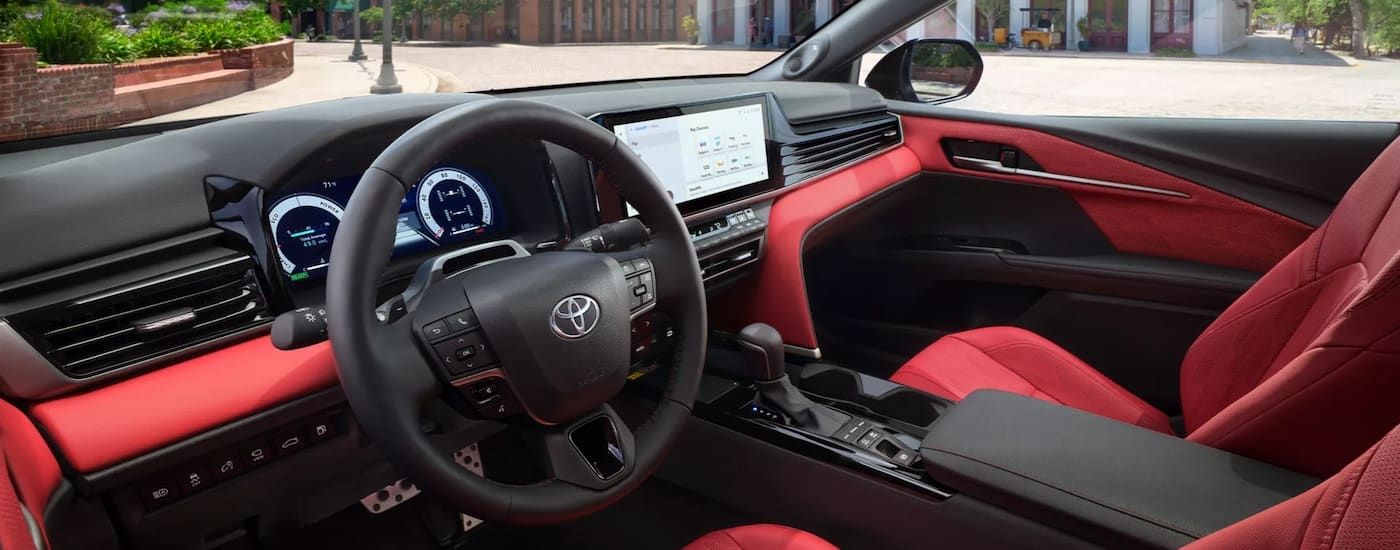 Red and black interior of a 2025 Toyota Camry.