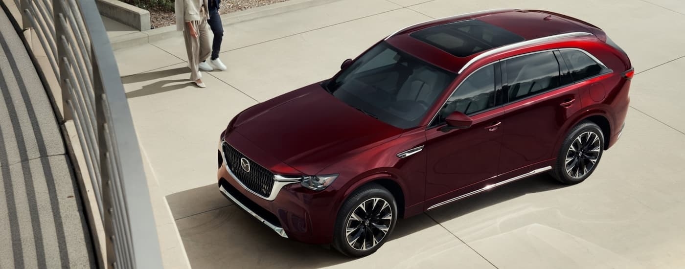 Red 2026 Mazda CX-90 Hybrid for sale parked on driveway.