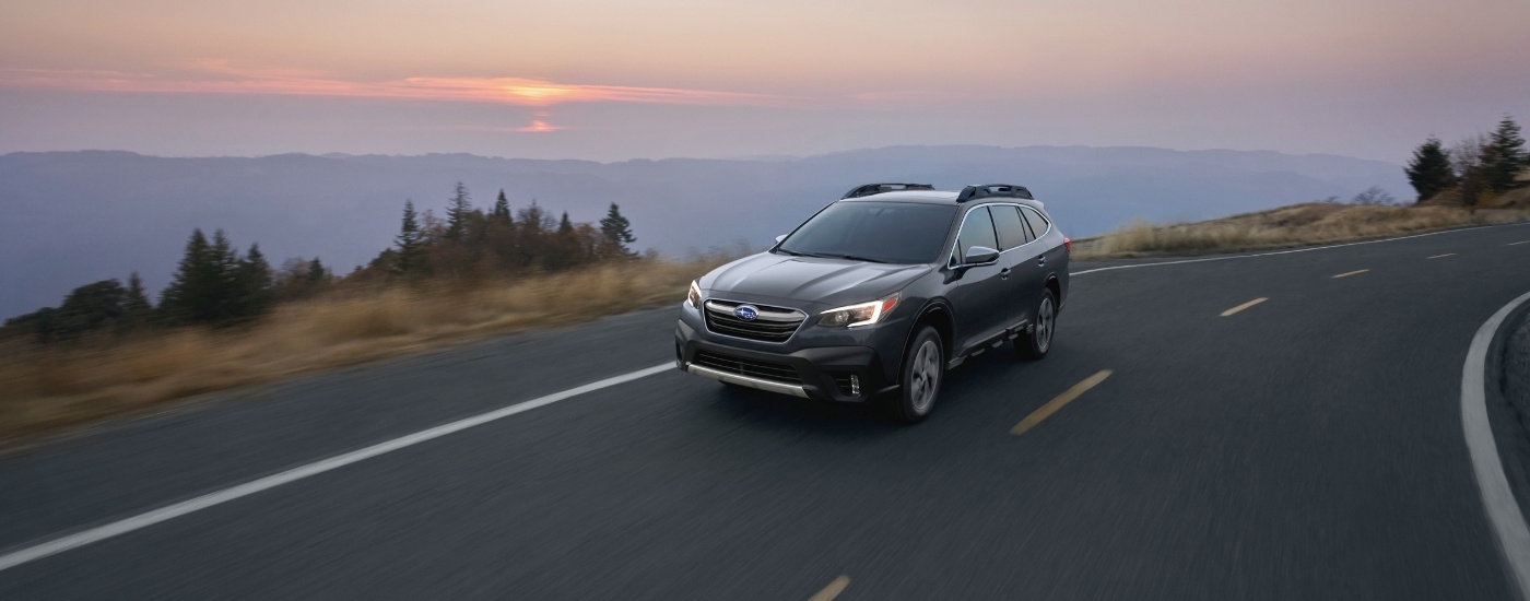 Grey 2020 Subaru Outback rounding a corner