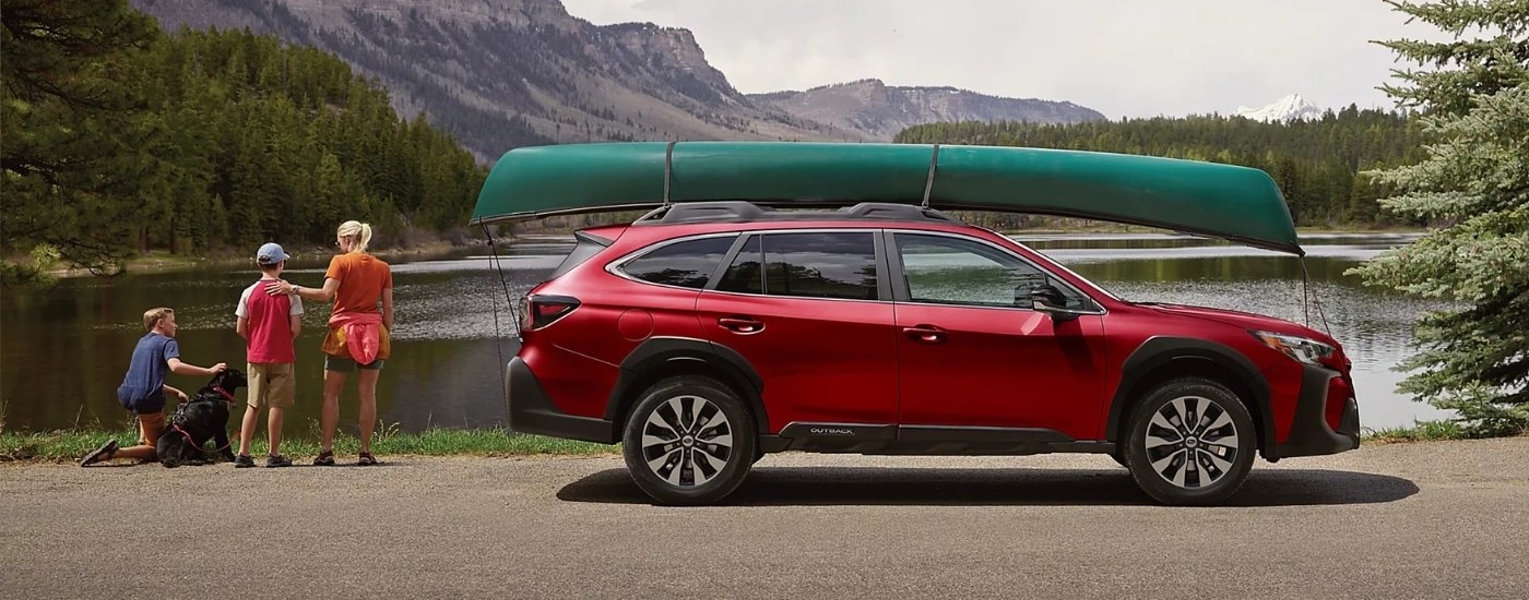 Red 2025 Subaru Outback for sale near Millbrook parked near a lake