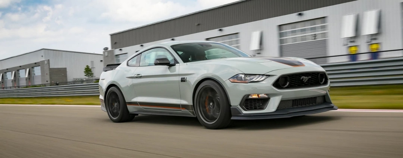 Grey 2022 Ford Mustang Mach 1 driving to a used car dealer near Kingston