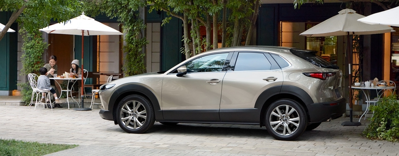 Tan 2025 Mazda CX-30 for sale near Coral Gables parked at a restaurant