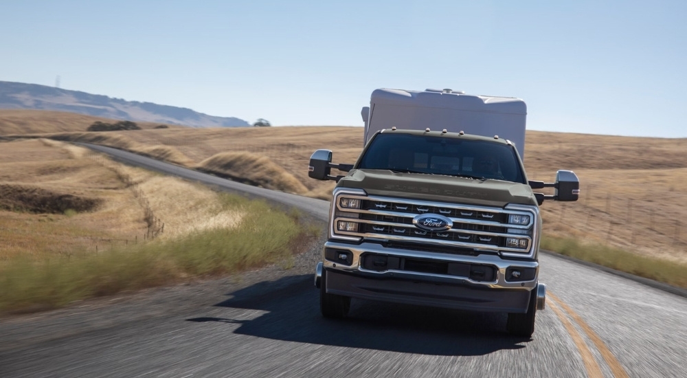 Tan 2025 Ford F-350 Lariat towing a trailer