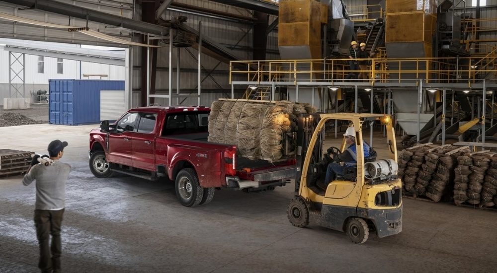 Red 2025 Ford F-350 Lariat in a warehouse