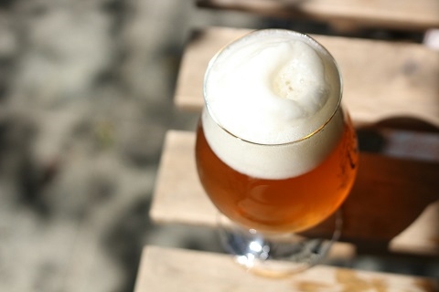 a glass of beer sitting on a table