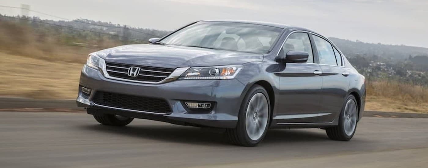 A silver 2013 Honda Accord driving on a highway.