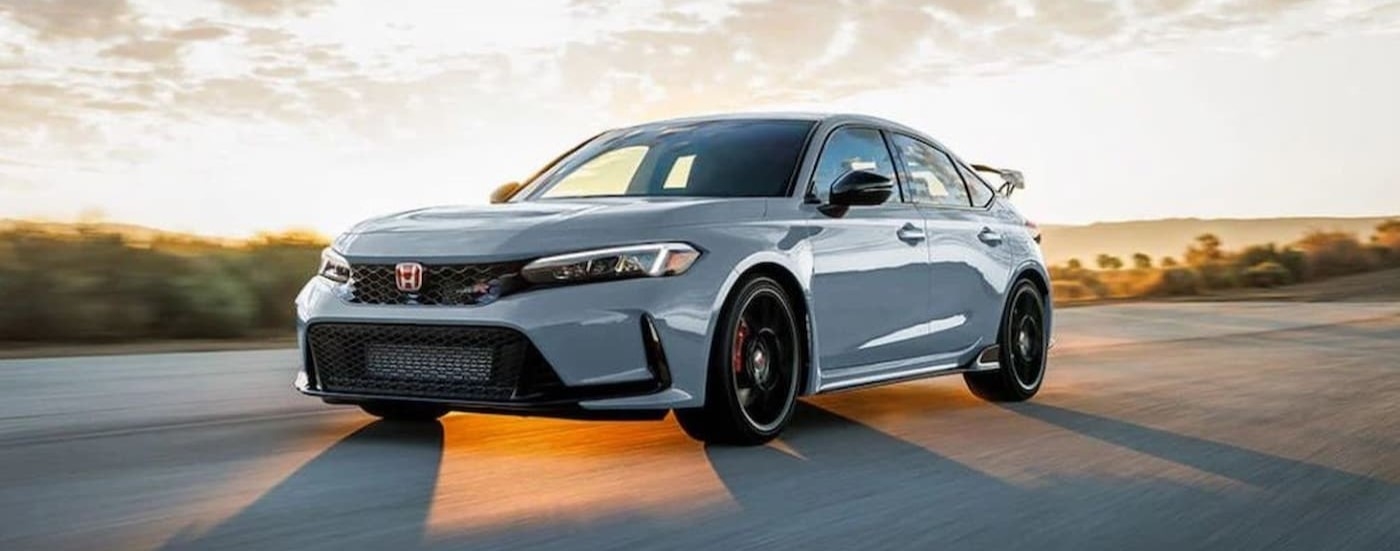 A white 2023 Honda Civic Type R driving fast.