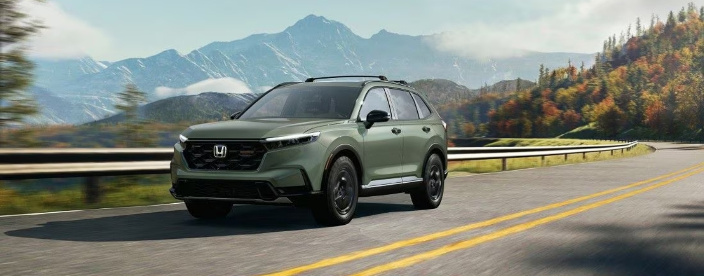 A green 2024 Honda CR-V from the front at an angle.
