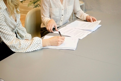 people signing car lease paperwork at the Volvo Cars Mission Viejo dealership in Mission Viejo, CA