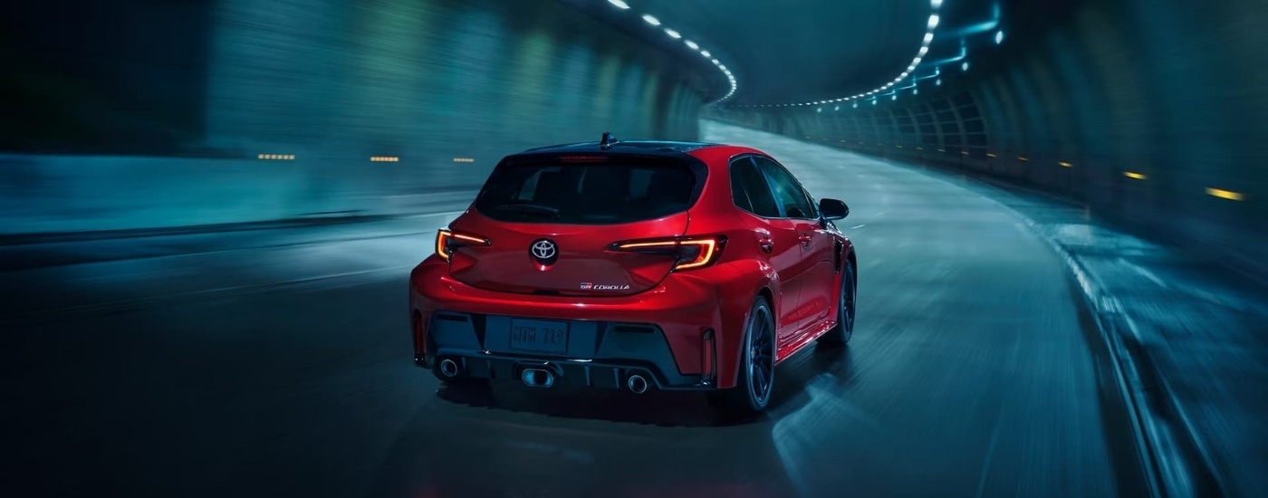 Red 2025 Toyota GR Corolla driving through a tunnel