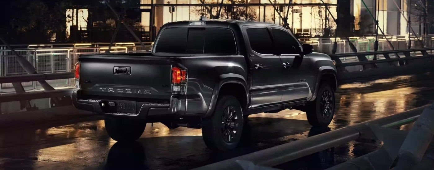Black 2023 Toyota Tacoma Limited Nightshade driving over a bridge