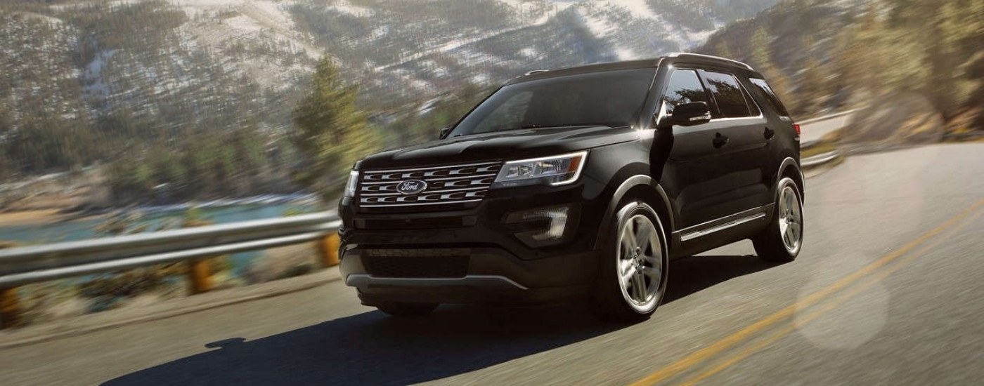 Black 2017 Ford Explorer for sale near Greenfield driving past mountains