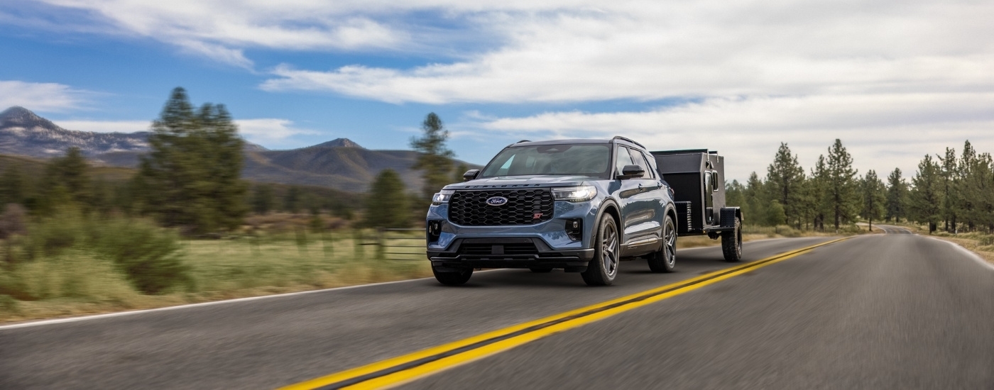 Blue 2026 Ford Explorer ST for sale near Claremont towing a trailer
